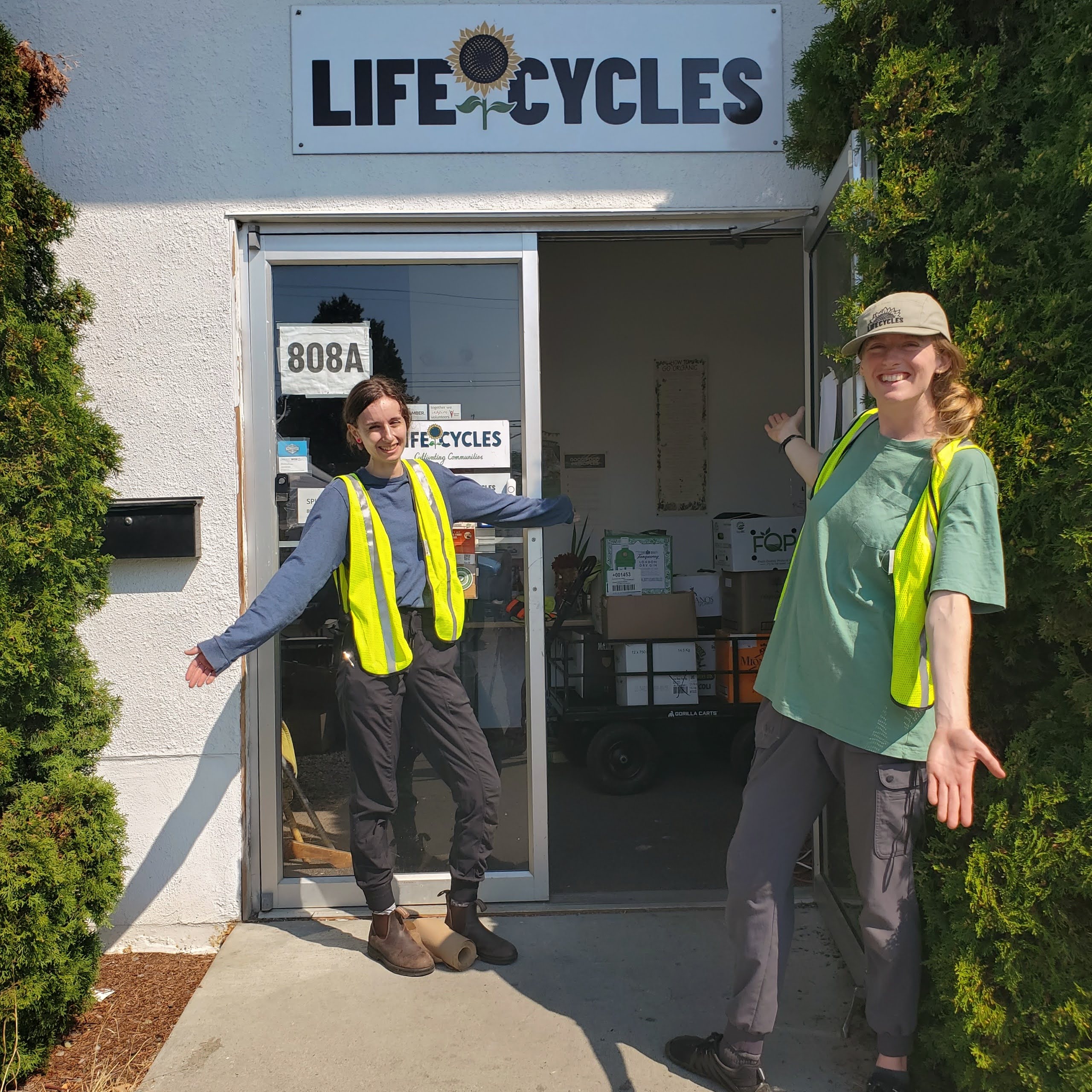 Two LifeCycles staff members standing in front of the LifeCycles office at the Esquimalt