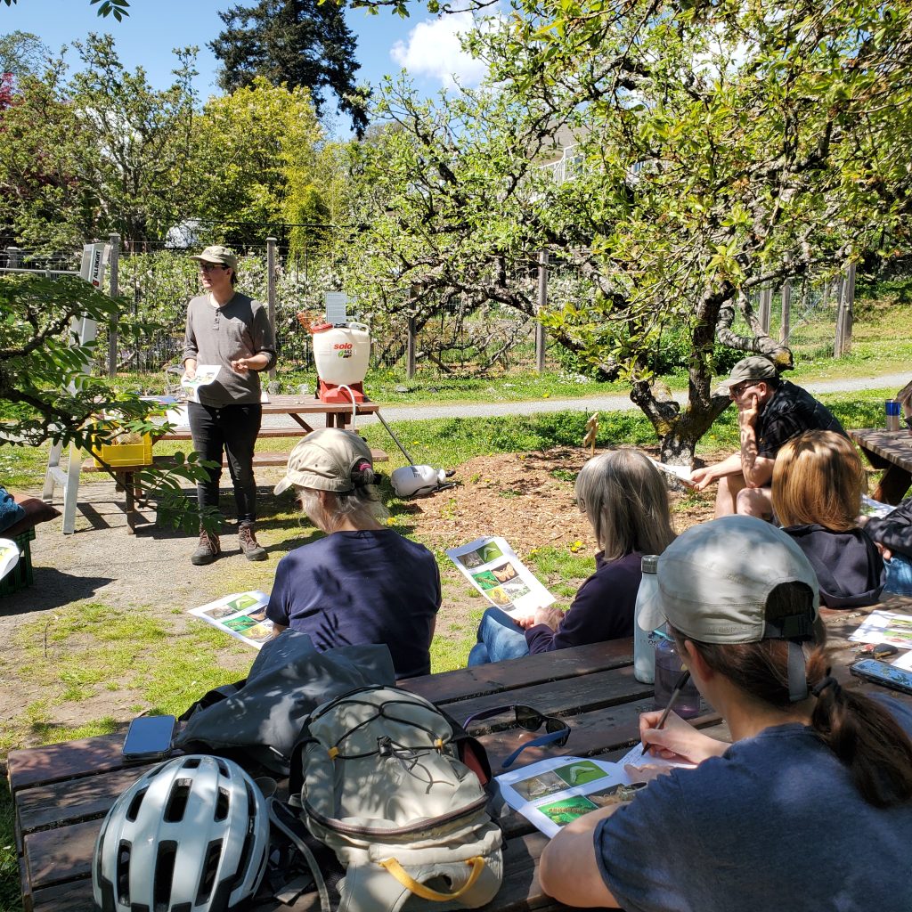 Orchard manager leading a workshop with seated participants at Welland Community Orchard.