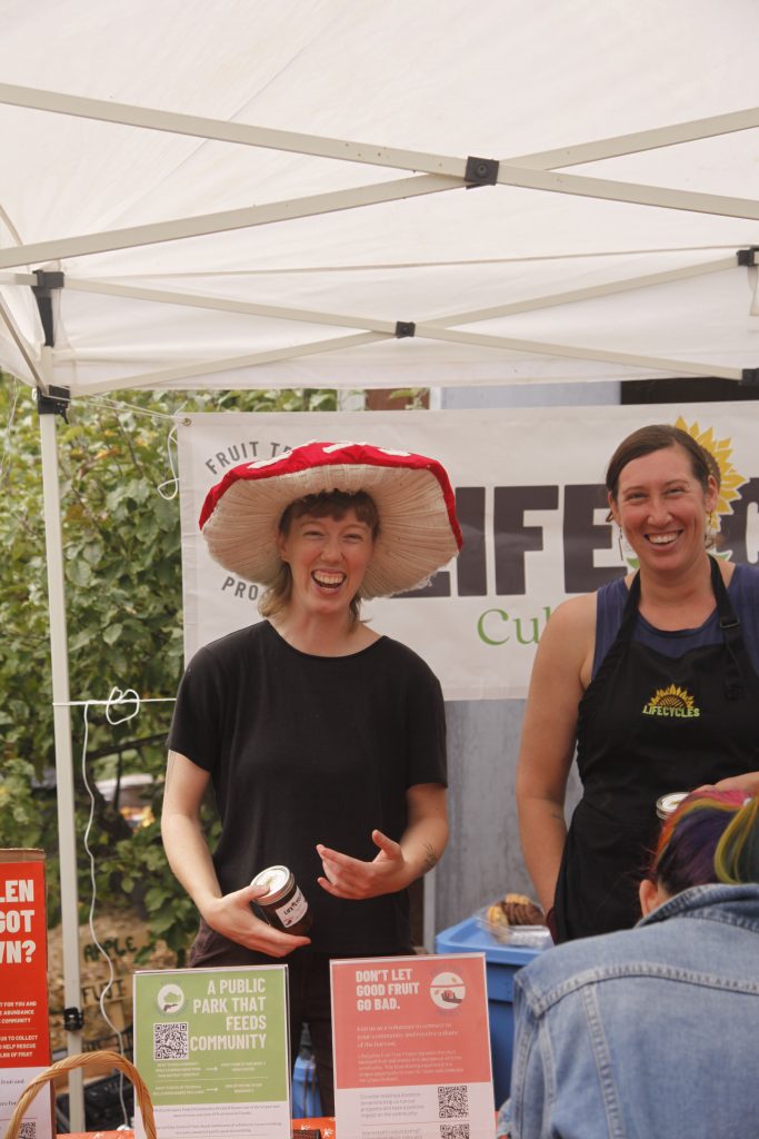 Two LifeCycles staff members at the information booth during Community Sharing Day.